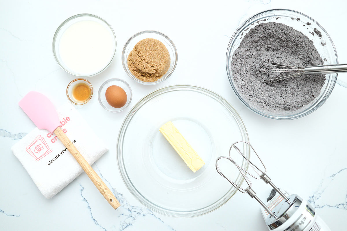 Ingredients and tools laid out for making the dark chocolate cakes