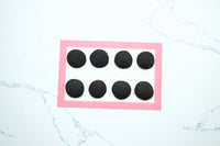 Baked dark chocolate whoopie pie cakes on a baking mat