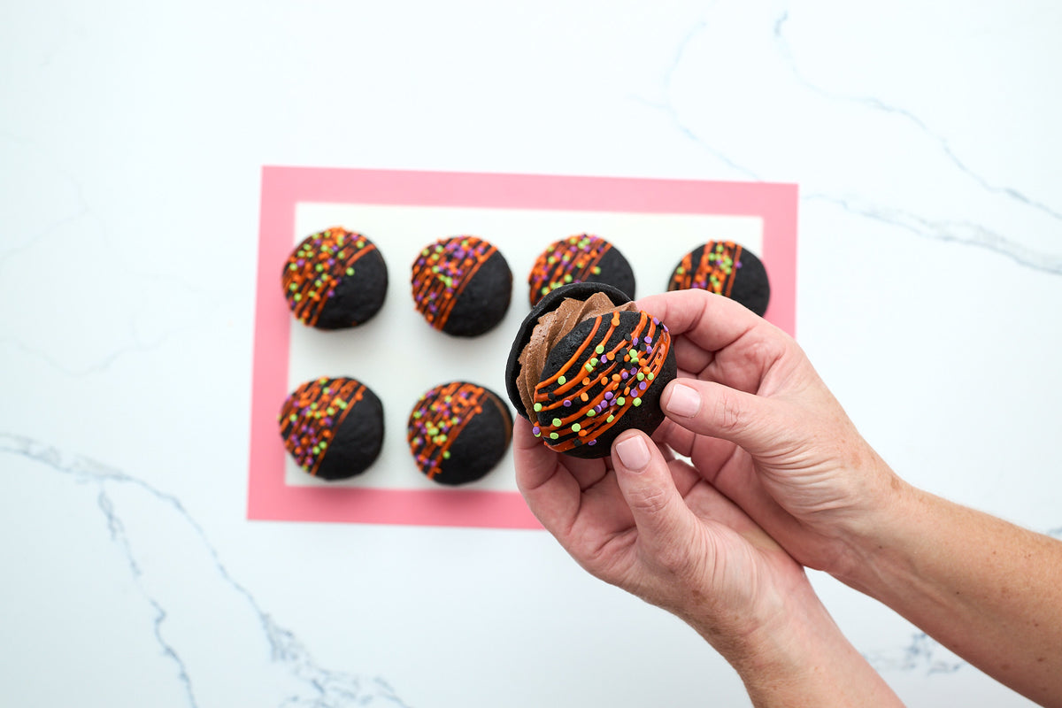Sandwiching two chocolate cakes together to finish a whoopie pie