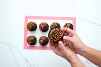 Sandwiching two chocolate cakes together to finish a whoopie pie