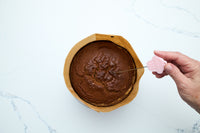 Testing the baked pumpkin cake with a cake tester