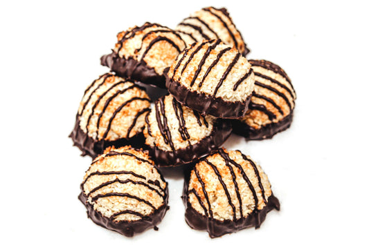 Coconut macaroons dipped in dark chocolate with chocolate drizzle.
