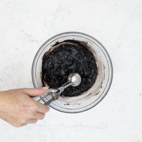 Scooping the chocolate cookie dough with the included cookie scoop